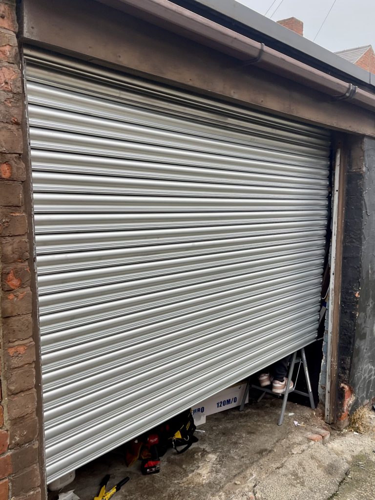 Emergency roller shutter repair at a hotel in Whitley Bay NE25 after rear access could not be secured, with new laths and motor installed