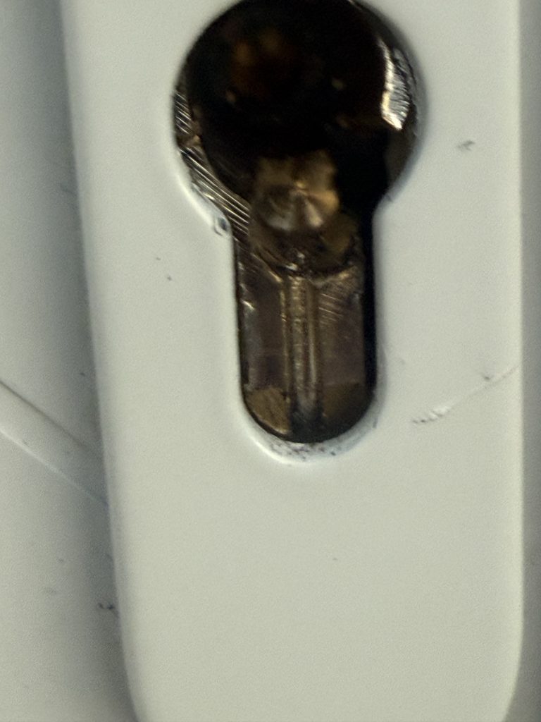 Close-up of drilled and damaged euro cylinder lock after rogue locksmith entry in Bedlington NE22
